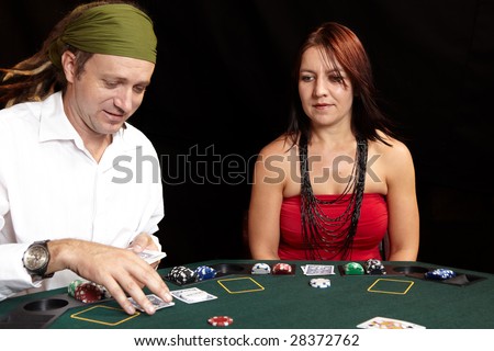 People playing cards, chips and players gambling around a green felt poker table. Shallow Depth of field, Focus on the Woman