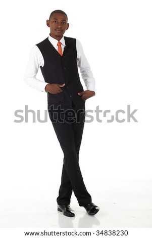 Young black african businessman in a formal suite and on a white background standing cross legged -