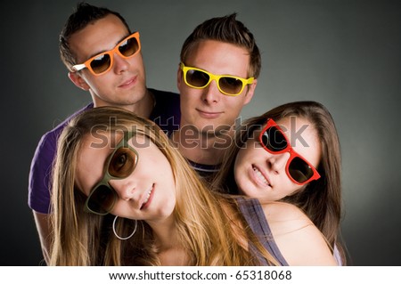 group of four persons with multi colored sunglasses