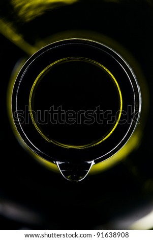 green wine bottle with drop isolated on black ground