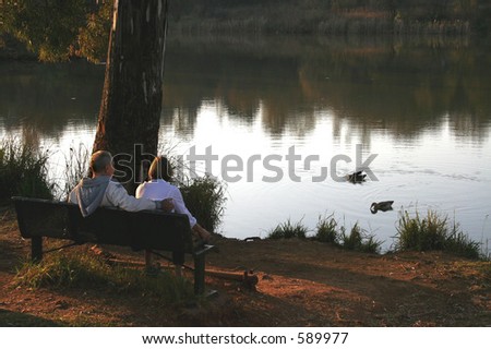 Old couple feeding ducks