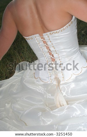 Wedding dress laced up on the back of a bride