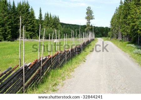 Old traditional fence by a country road