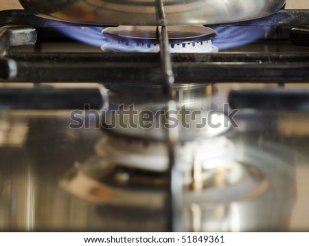 gas burner flame with reflection in kitchen