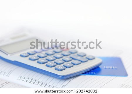 Credit card and calculator on an open diary. Shallow dof