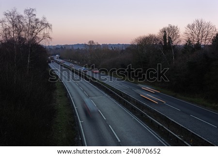 Traffic on a main road in the UK in winter at sunset. Travel concept.