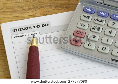 Pen and calculator on a \'Things To Do\' pad