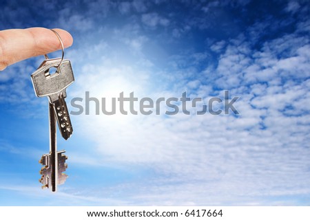 Finger with key on blue sky background