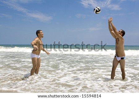 Two man playing volleyball at the beach