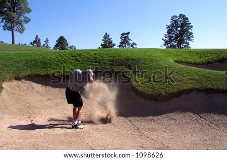 Golfer hitting out of a sand trap (2 of 3 shot action sequence)