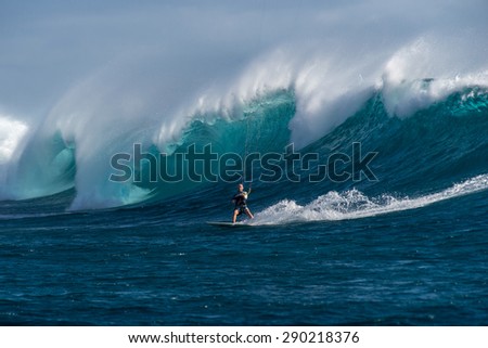 Kite surfer rides among the huge tubes and waves of the Indian Ocean on the island of Mauritius