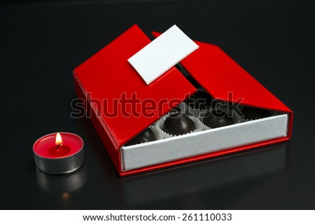 Opened box of chocolate bonbons / Red box of chocolate opened/ Chocolate bonbons in chocolate box isolated