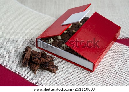 Opened box of chocolate/Red box of chocolate open/Peanuts chocolate in chocolate box