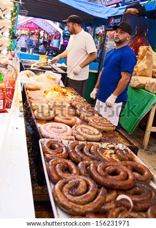 NEW YORK CITY - SEPTEMBER 22: Vendors cooking and serving food at the San Gennaro festival in New York City on September 22, 2013.