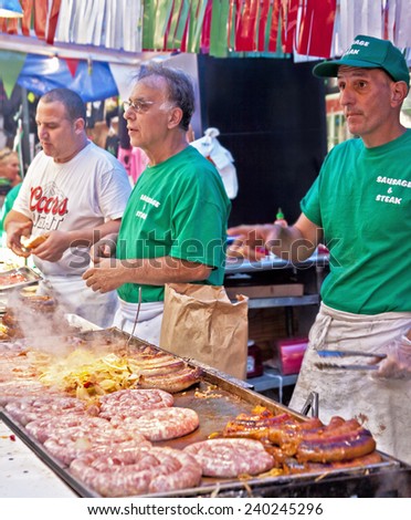 NEW YORK CITY - SEPTEMBER 22: Vendors cooking and serving food at the San Gennaro festival in New York City on September 22, 2013.