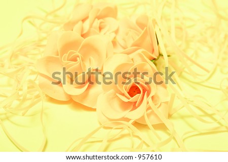 The background image from artificial roses in yellow gentle tones