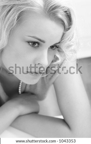 Portrait of the romantic sad woman with beautiful light hair. It is black a white photo