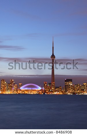 Toronto skyline complete with CN Tower and Rogers Centre (SkyDome) at night.