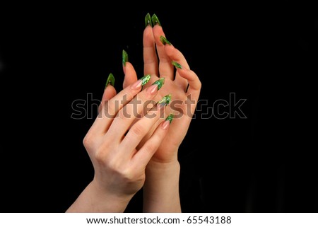 Human fingers with long fingernail and beautiful manicure isolated on black