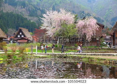 SHIRAKAWA, JAPAN - APRIL 28: Tourists visit old village on April 28, 2012 in Shirakawa-go, Japan. Shirakawa is one of most popular attractions in Japan, listed as UNESCO World Heritage Site since 1995