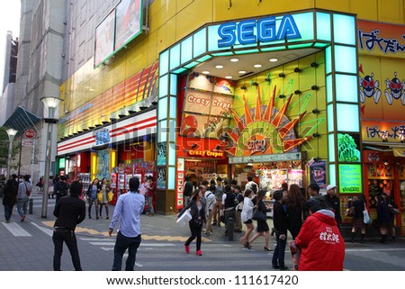 TOKYO - MAY 11: People visit Sega Ikebukuro arcade game centre on May 11, 2012 in Tokyo. Sega is a profitable company with US $4.9 billion revenue in 2011. It exists since 1940.