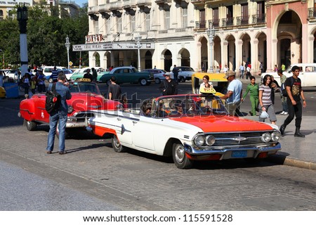 HAVANA - JANUARY 30: Cubans drive Classic American cars on January 30, 2011 in Havana. Recent change in law allows the Cubans to trade cars again. Most cars in Cuba are very old because of the old law