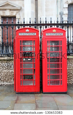 London, United Kingdom - red telephone boxes in wet rainy weather.