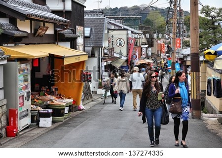 KYOTO, JAPAN - APRIL 16: Tourists walk on April 16, 2012 in Kyoto, Japan. Old Kyoto is a UNESCO World Heritage site and was visited by almost 1 million foreign tourists in 2010.