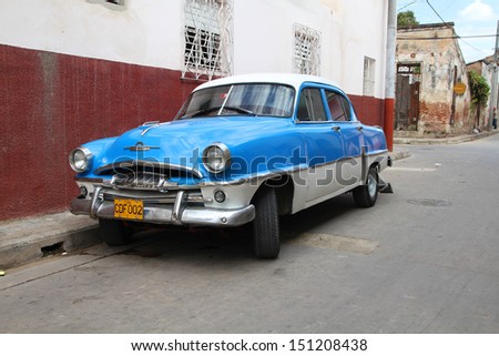 CAMAGUEY - FEBRUARY 18: Classic Plymouth car parked in street on February 18, 2011 in Camaguey, Cuba. New change in law allows Cubans to trade cars. Cars in Cuba are very old because of the old law.