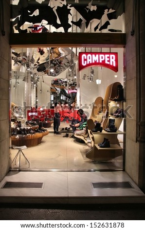 BARCELONA, SPAIN - NOVEMBER 5: People visit Camper store on November 5, 2012 in Barcelona, Spain. Spanish shoe company exists since 1975, has 52 own stores and distributes to many multibrand stores.