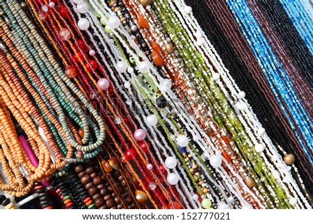 Colorful beads background - necklaces at a store. Abstract jewellery.
