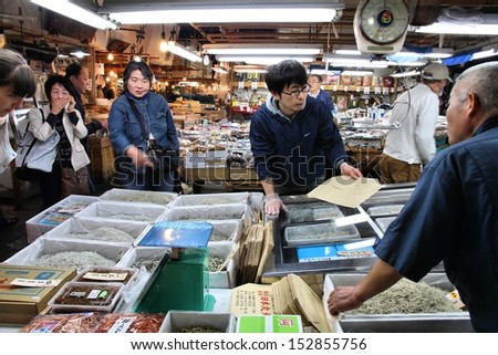 TOKYO - MAY 11: People visit famous Tsukiji Fish Market on May 11, 2012 in Tokyo. It is the biggest wholesale fish and seafood market in the world.