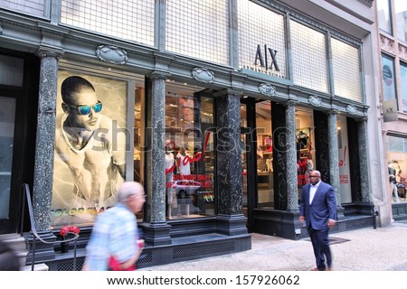 NEW YORK - JULY 3: People walk past Armani Exchange fashion store on July 3, 2013 in 5th Avenue, New York. Giorgio Armani group had 1.8 billion EUR in revenue in 2011.