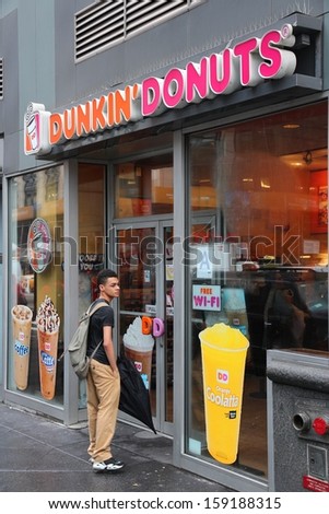 NEW YORK - JUNE 10: Person visits Dunkin Donuts shop on June 10, 2013 in New York. The company is the largest coffee and baked goods franchise in the world, with 15,000 stores in 37 countries.