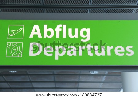 Airport sign in Germany - departures green sign in German and English