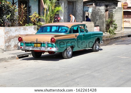 SANTIAGO, CUBA - FEBRUARY 10: Classic car parked in the street on February 10, 2011 in Santiago. Recent change in law allows Cubans to trade cars again. Old law resulted in old fleet of private cars.
