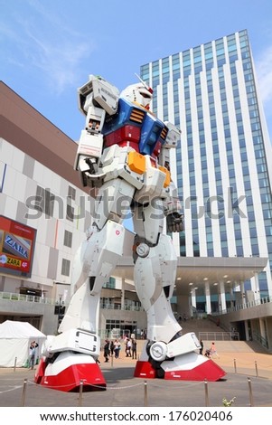 TOKYO, JAPAN - MAY 11, 2012: People visit Gundam robot replica in Odaiba,Tokyo. The sculpture is 18m tall and is the tallest replica of famous anime franchise robot, Gundam.