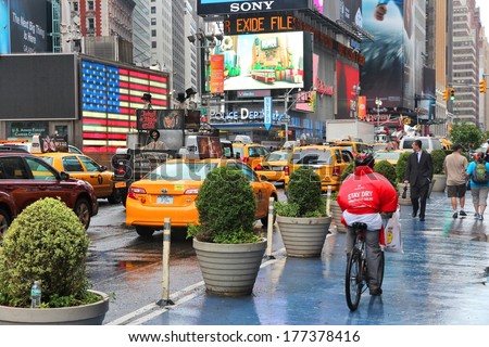 NEW YORK, USA - JUNE 10, 2013: People visit Times Square in New York. Times Square is one of most recognized landmarks in the world. More than 300,000 people pass through Times Square daily.