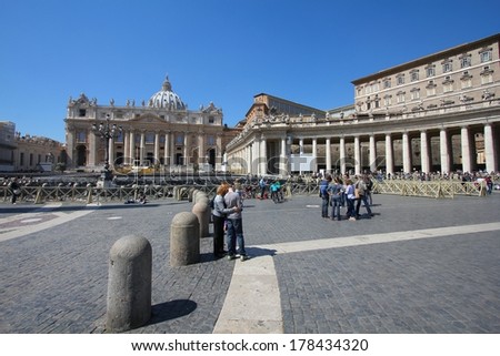 VATICAN CITY, VATICAN - APRIL 10, 2012: People visit Saint Peter\'s Square in Vatican City, Vatican. Saint Peter\'s Square is among most popular pilgrimage sites for Roman Catholics.