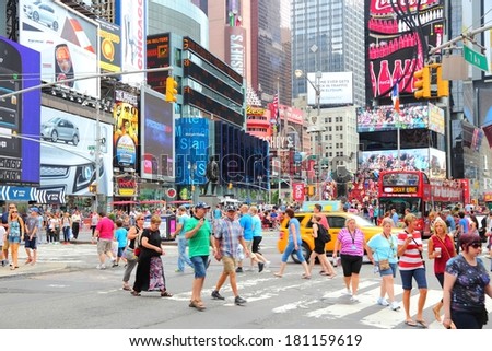 NEW YORK, USA - JULY 4, 2013: People visit Times Square in New York. Times Square is one of most recognized landmarks in the world. More than 300,000 people pass through Times Square daily.