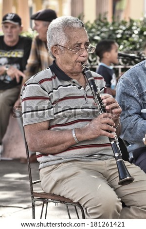 REMEDIOS, CUBA - FEBRUARY 20, 2011: Amateur orchestra man plays the clarinet in Remedios, Cuba. Remedios is one of the oldest towns in Cuba, dating back to 1513.