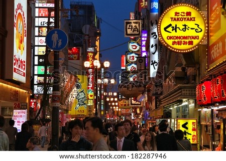 OSAKA, JAPAN - APRIL 25, 2012: People visit famous Dotonbori street in Osaka, Japan. According to Tripadvisor Dotonbori is the 3rd best attraction to visit in Osaka.