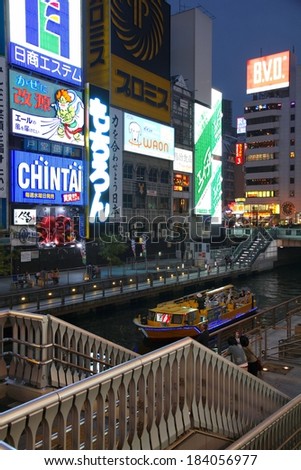OSAKA, JAPAN - APRIL 25, 2012: People visit Dotonbori area of Osaka, Japan. Osaka is Japan\'s 3rd largest city by population with 18 million people living in its urban area.