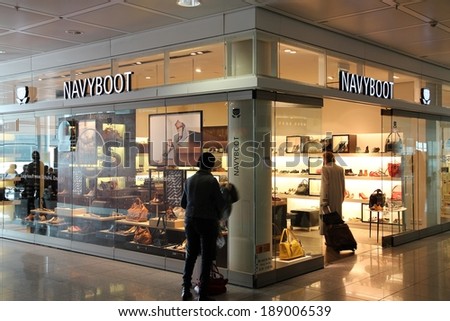 MUNICH, GERMANY - APRIL 1, 2014: People visit Navyboot store at Munich International Airport in Germany. Navyboot is a rising Swiss brand founded in 1991. It has 58 stores in Switzerland and Germany.