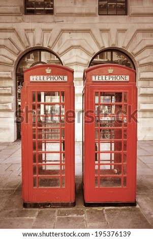 London, United Kingdom - red telephone booths. Phone boxes. Cross processing color tone - filtered retro style.