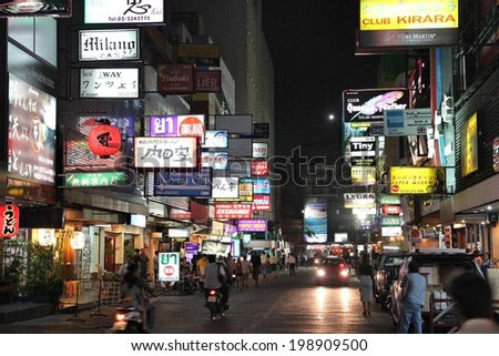 BANGKOK, THAILAND - DECEMBER 21, 2013: People visit Patpong in Bangkok. Patpong is the Bangkok\'s entertainment district. Bangkok is Thailand\'s capital city, 8.3 million people live here.