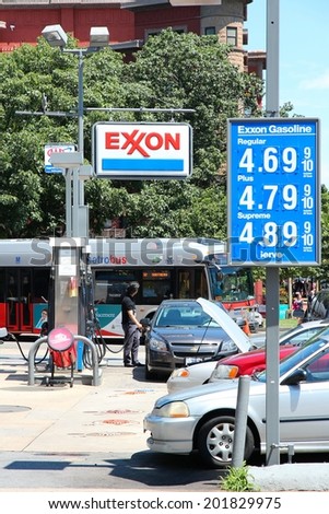 WASHINGTON, USA - JUNE 14, 2013: People visit Exxon gas station in Washington, DC, USA. ExxonMobil is the 3rd largest company in the world by revenue (420 billion USD in 2013).