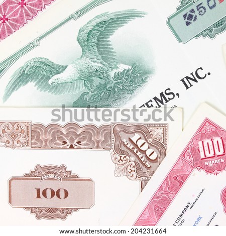 Stock market collectibles. Old stock share certificates from 1950s-1970s (United States). Vintage scripophily objects (obsolete). Square composition.
