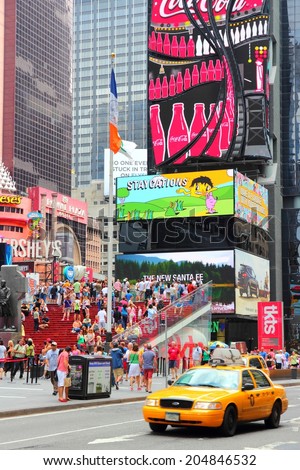 NEW YORK, USA - JULY 4, 2013: People visit Times Square in New York. Times Square is one of most recognized landmarks in the world. More than 300,000 people pass through Times Square daily.