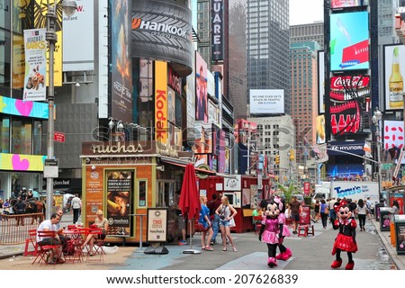 NEW YORK, USA - JULY 3, 2013: People visit Times Square in New York. Times Square is one of most recognized landmarks in the world. More than 300,000 people pass through Times Square daily.